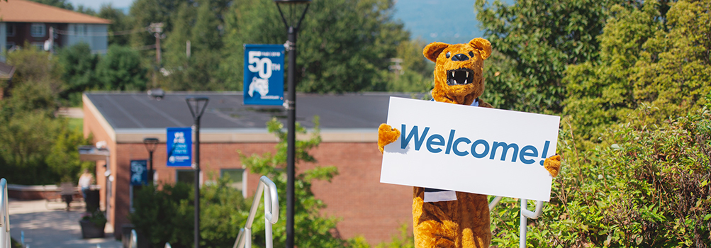 Nittany Lion Mascot with a Welcome sign