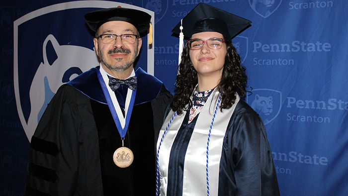 man and woman in graduation attire