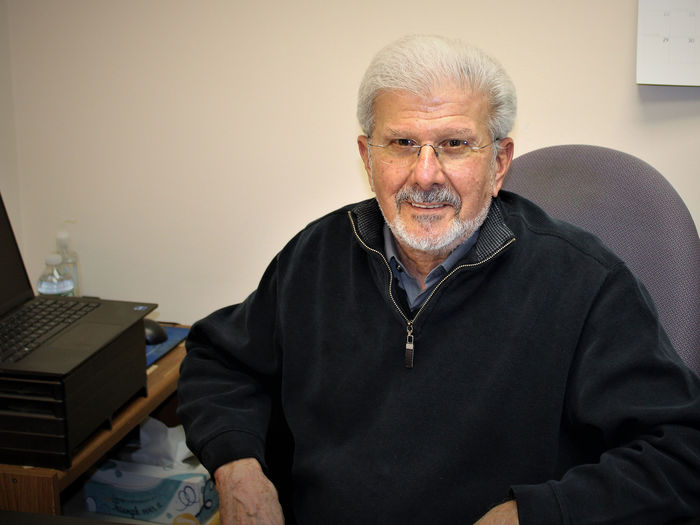 Paul Perrone seated in his office at his desk