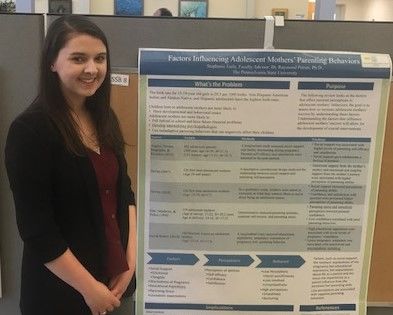 Student Stephanie Earle standing near her poster at the Penn State Eastern Regional Undergraduate Research Symposium at Penn State Hazleton, 2019