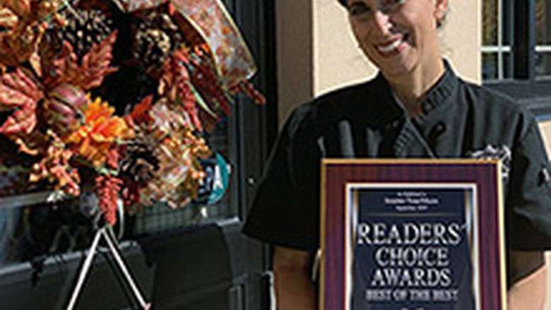 Laura Reuther holds the store's 2019 Readers' Choice Award from the Scranton Times-Tribune