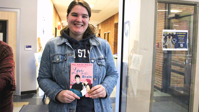 Student Chloe Tucker shows off her book, love on the brain.