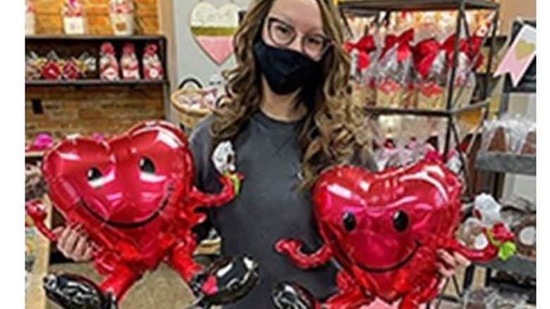 Jacqueline Reuther shows off some the Candy Kitchen's Valentine's Day decorations inside the store